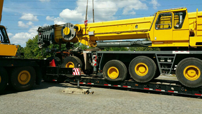 Export Logistics & Shipping, Inc. lifts Grove GMK6250 crane onto flat rack with jib hooks
